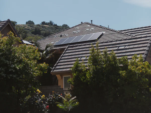 Home with solar panels on a tile roof